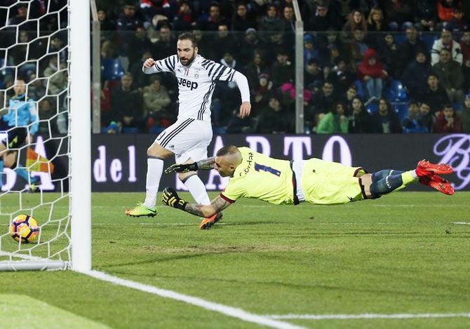 Juventus' Gonzalo Higuain scores against Crotone during their Italian Serie A match at Ezio Scida stadium in Crotone on Wednesday