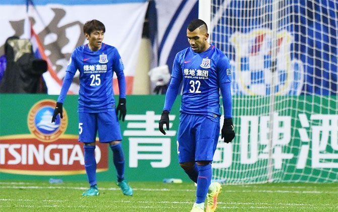 Shanghai Greenland Shenhua FC's Carlos Tevez wears a dejected look after the Asian Champions League qualifiers against Brisbane Roar on Wednesday