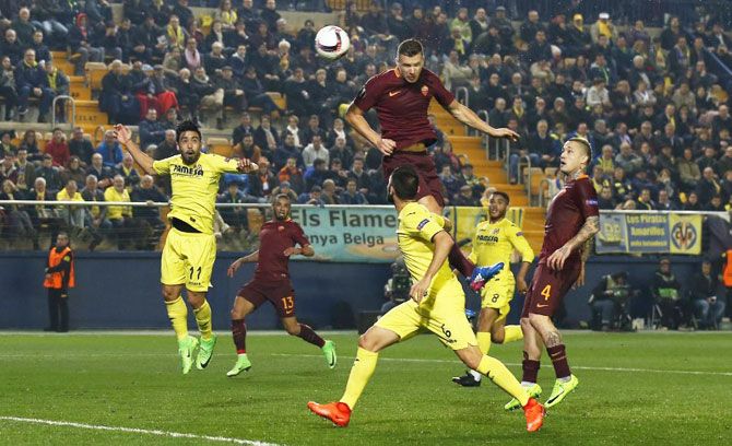 Roma's Edin Dzeko heads at goal during their UEFA Europa League Round of 32 First Leg match against Villareal at Estadio de la Ceramica, in Villarreal on Thursday