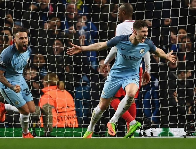 Manchester City's John Stones (right) says he is 'developing as a player and a person under Guardiola'
