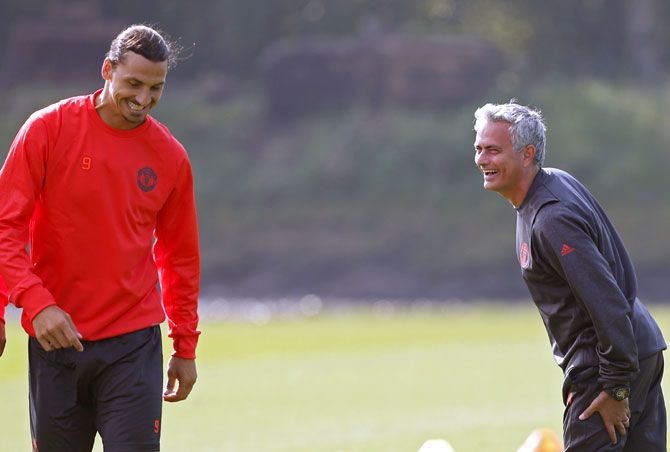 Manchester United manager Jose Mourinho, right, speaks to Zlatan Ibrahimovic