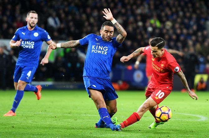 Liverpool's Philippe Coutinho is involved in a hard tackle with Leicester City's Danny Simpson, leading to an injury to latter