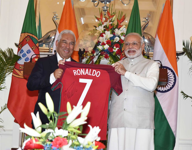 Portugal's PM Antonio Costa presents Indian PM Narendra Modi with a jersey signed by Portugal's football star Cristiano Ronaldo