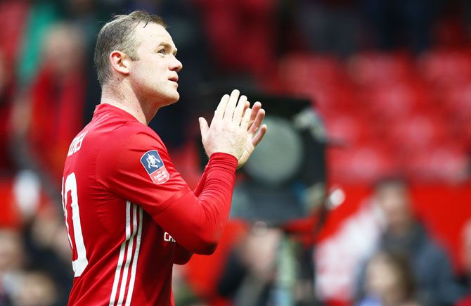 Manchester United's Wayne Rooney applauds supporters following victory over Reading FC in the FA Cup third round match at Old Trafford on Saturday