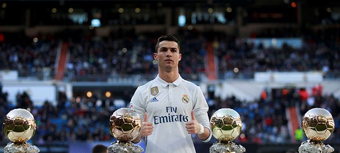  Two days before the event, January 7, Ronaldo poses with his 4 Ballon d'Ors before a game against Granada at the Bernabeu stadium in Madrid. Photograph: Reuters
