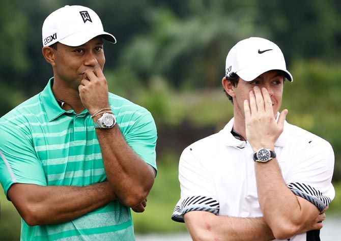 Tiger Woods, left, with Rory McIlroy. Photograph: Lintao Zhang/Getty Images