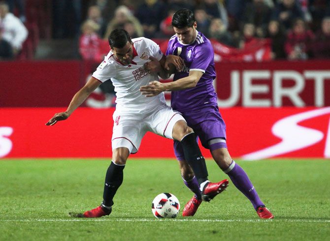 Real Madrid's Alvaro Morata (right) and Sevilla's Gabriel Mercado vie for possession