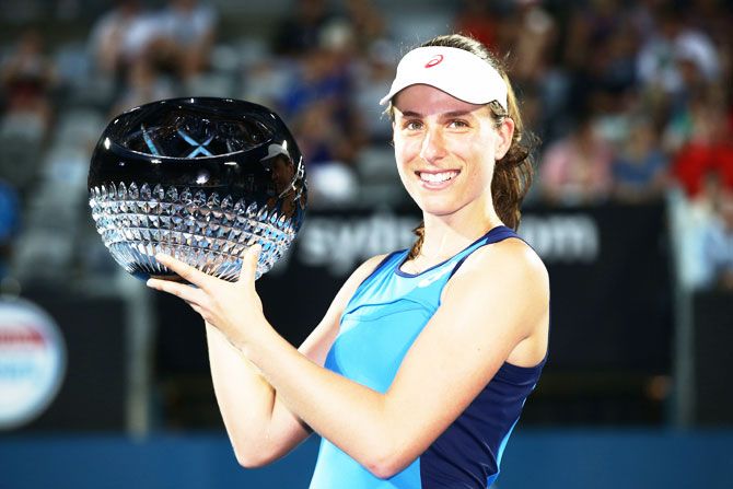 Great Britain's Johanna Konta poses with the winners' trophy after defeating Poland's Agnieszka Radwanska to win the Sydney International at Sydney Olympic Park Tennis Centre in Sydney on Friday