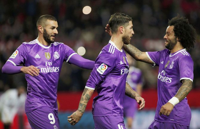 Real Madrid's Karim Benzema (left), Sergio Ramos and Marcelo celebrate a goal against Sevilla during their King's Cup match