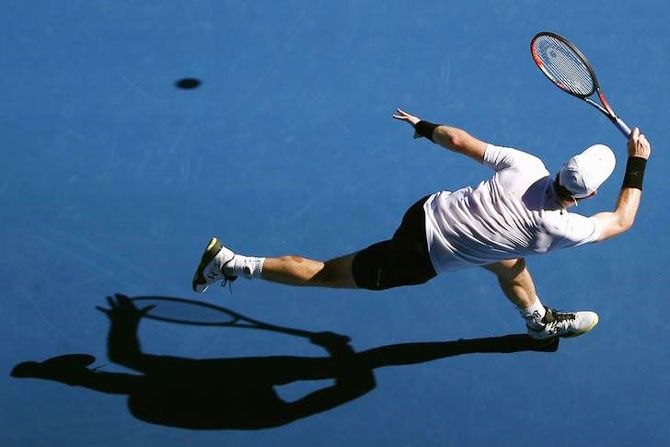 Britain's Andy Murray casts a shadow as he hits a shot during his first round match against Ukraine's Illya Marchenko at the Australian Open on Monday