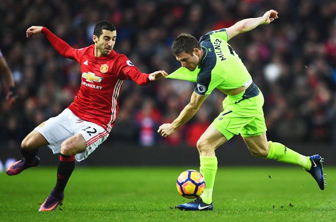 Manchester United's Henrikh Mkhitaryan and Liverpool's James Milner battle for the ball
