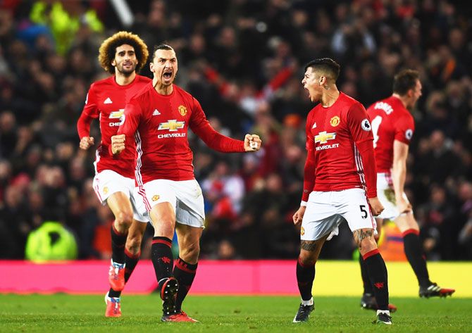 Manchester United's Zlatan Ibrahimovic celebrates with teammates on scoring the equalising goal against Liverpool during their English Premier League match at Old Trafford in Manchester on Sunday
