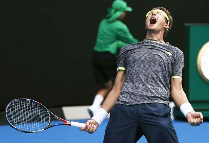 Uzbekistan's Denis Istomin is ecstatic after defeating defending champion Serbia's Novak Djokovic in their Autralian Open second round match at Melbourne Park on Thursday