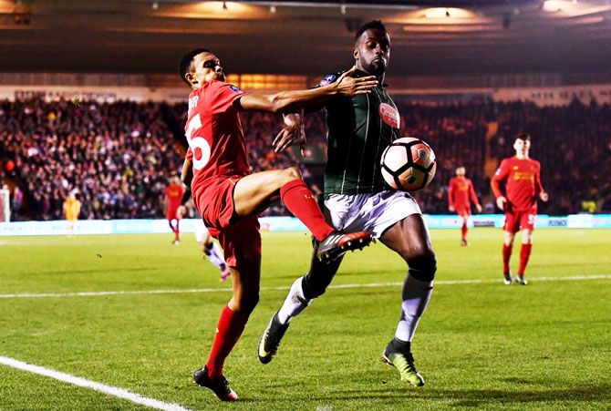 Liverpool's Trent Alexander-Arnold challenges Plymouth Argyle's Jordan Slew during The Emirates FA Cup third round replay match at Home Park in Plymouth, England, on Wednesday