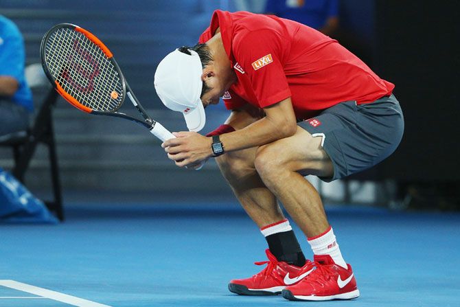 Kei Nishikori cuts a disappointed figure after missing a point during his fourth round match against Roger Federer on Sunday