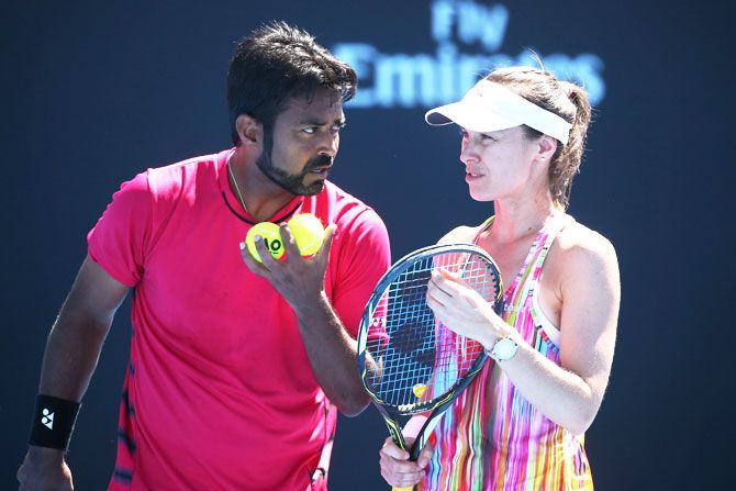 Switzerland's Martina Hingis and India's Leander Paes discuss tactics in their first round match against Australia's Destanee Aiava and Marc Polmans on Day 7 of the 2017 Australian Open at Melbourne Park on Sunday