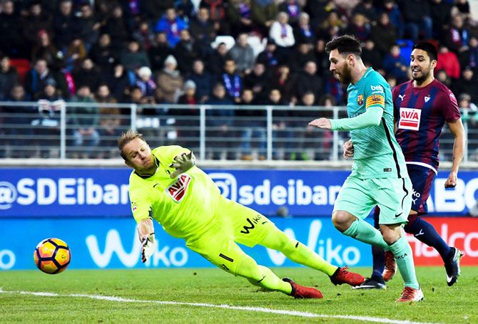 FC Barcelona's Lionel Messi scores his team's second goal past the goalkeeper SD Eibar's Yoel during their La Liga match at Ipurua stadium in Eibar, Spain, on Sunday