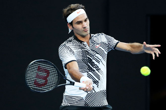 Switzerland's Roger Federer plays a forehand in his quarter-final match against Germany's Mischa Zverev on day nine of the 2017 Australian Open at Melbourne Park on Tuesday
