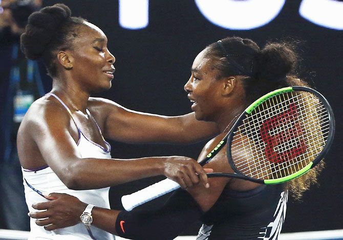 Venus Williams and Serena Williams hug at the net after the Australian Open final on Saturday