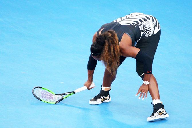 Serena Williams smashes her racquet in frustration