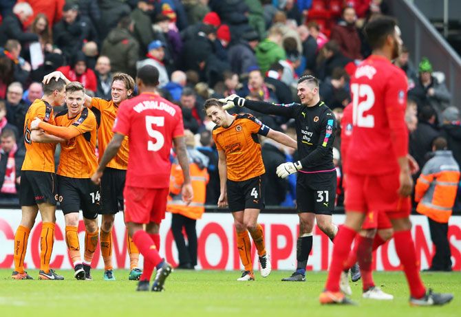 Wolverhampton Wanderers' players celebrate after defeating Liverpool in the Emirates FA Cup fourth round match at Anfield on Saturday
