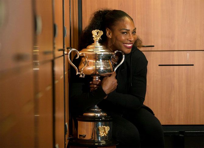 Serena Williams shows off Daphne Akhurst Memorial Cup in the locker room after winning the Australian Open title