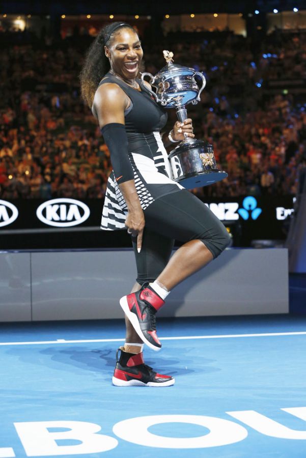 Serena Williams poses with her trophy after winning the Australian Open singles final after defeating Venus Williams on Saturday