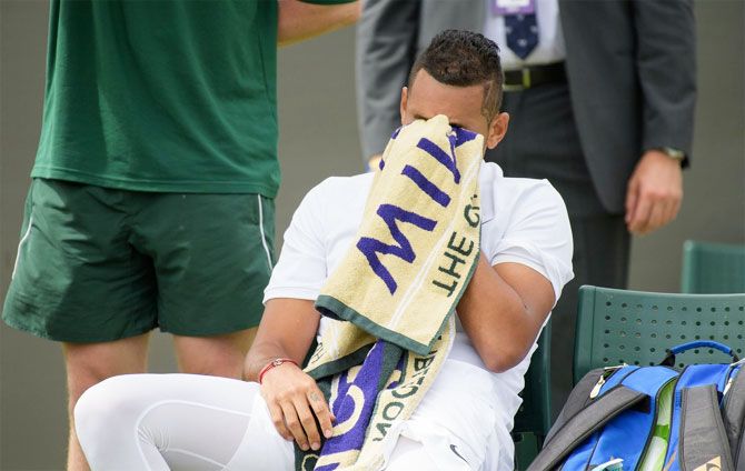 Australia's Nick Kyrgios wears a dejected look during his first round match against Pierre-Hugues Herbert at the Wimbledon Championships in London on Monday