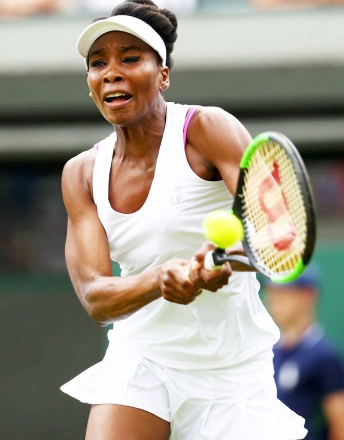 Venus Williams of the United States plays a backhand during her first round match against Elise Mertens at Wimbledon on Monday