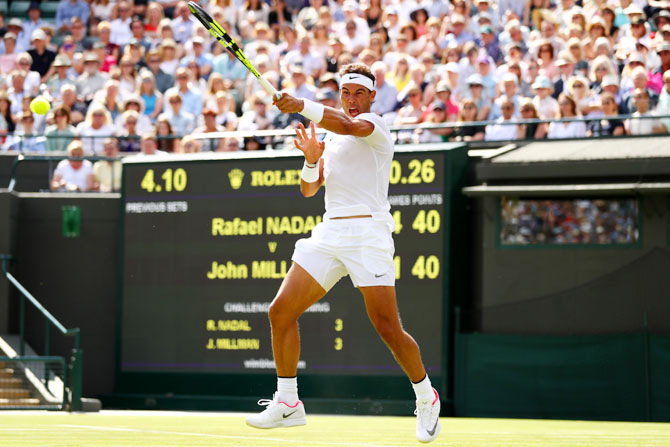Spain'S Rafael Nadal plays a forehand during his Wimbledon first round singles match against Australia's John Millman at the All England Lawn Tennis and Croquet Club in London on Monday