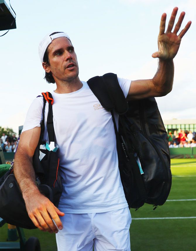 Germany's Tommy Haas acknowledges the crowd after losing his first round match against Belgium's Ruben Bemelmans at the Wimbledon Lawn Tennis Championships at the All England Lawn Tennis and Croquet Club in London on Monday