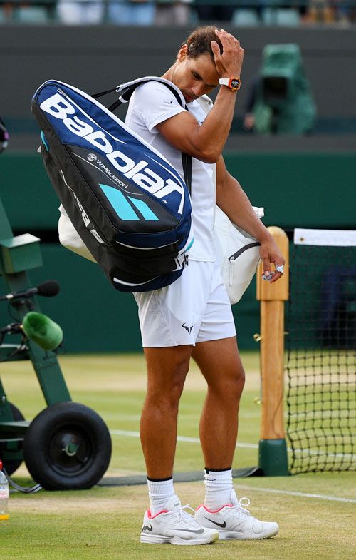 Rafael Nadal wears a dejected look after his defeat in the Wimbledon fourth round match against Gilles Muller on Monday