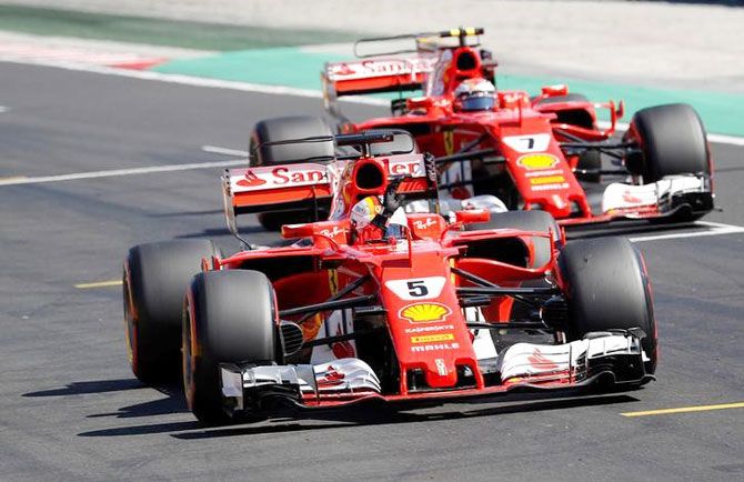 Ferrari's Sebastian Vettel (left) celebrates getting pole as he trailed by Kimi Raikkonen (right), who got second place during qualifying at the Hungarian Grand Prix in Budapest on Saturday