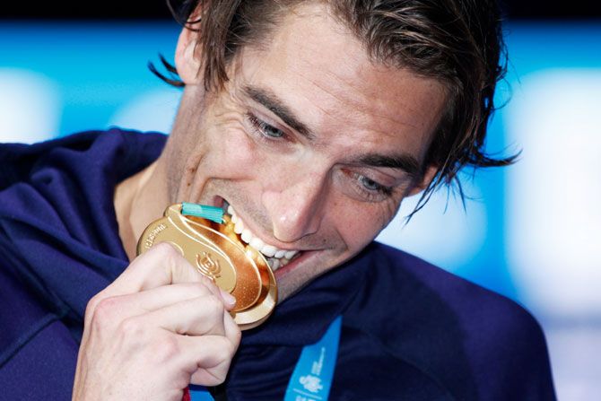 Camille Lacourt of France celebrates his gold medal in the Men's 50m Backstroke Final on Sunday