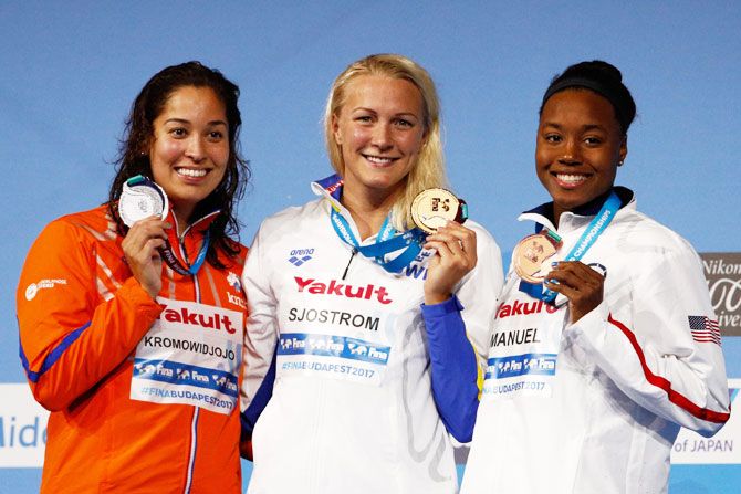 (Left-Right) Silver medalist Ranomi Kromowidjojo of the Netherlands, gold medalist Sarah Sjostrom of Sweden and bronze medalist Simone Manuel of the United States pose with the medals won in the Women's 50m Freestyle Final on Sunday