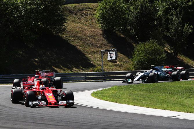 Sebastian Vettel of Germany driving the (5) Scuderia Ferrari SF70H leads the field round the second corner during the Formula One Grand Prix of Hungary at Hungaroring circuit