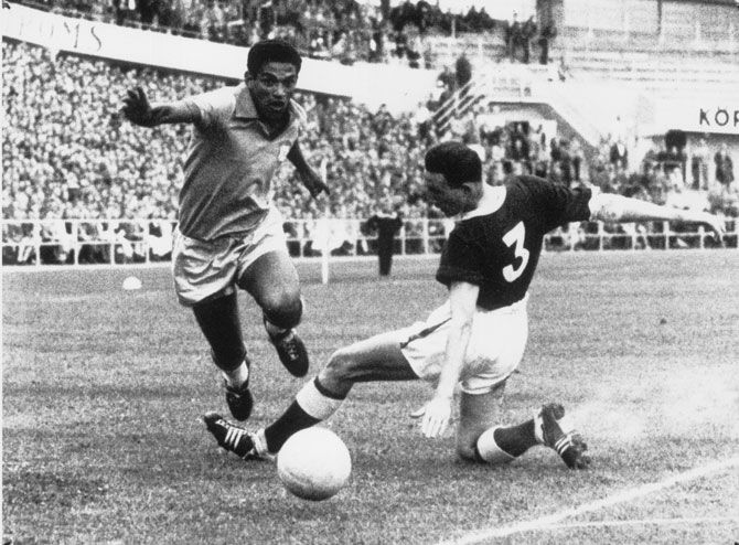 A file photo of Brazilian right winger Garrincha (left) and Welsh player Hopkins vieing for possession