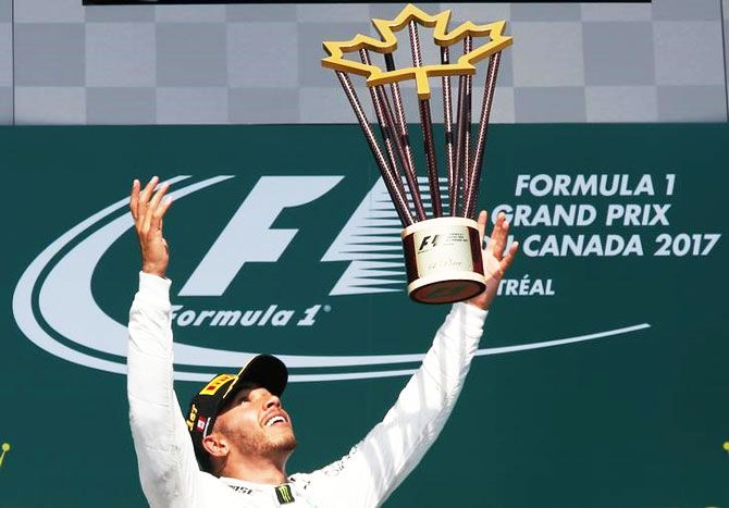 Mercedes’ Lewis Hamilton celebrates with the trophy after winning the Canadian F1 GP in Montreal, Quebec on Sunday