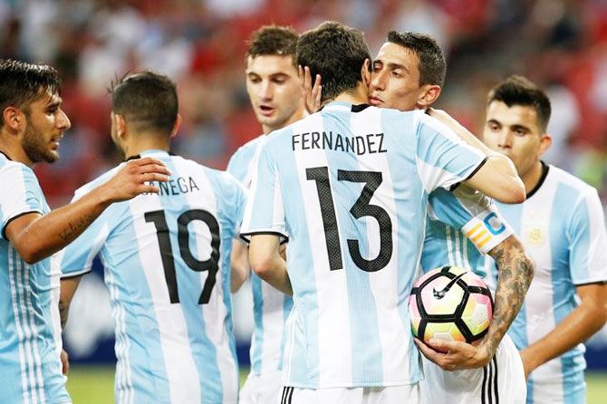 Argentina's Angel Di Maria (2nd R) celebrates with his teammates after scoring against Singapore during their international friendly at National Stadium in Singapore on Tuesday