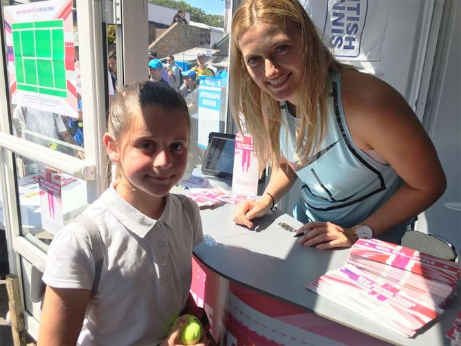 Kvitova pulled out of the Aegon International with a abdominal muscle injury, is seen her giving an autograph to a young fan in Eastbourne
