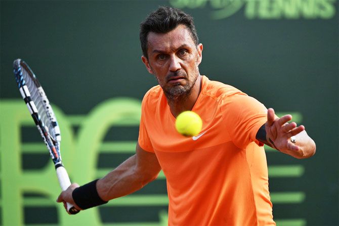 Paolo Maldini in action during his pro tennis debut doubles match at the Aspria Tennis Cup in Milan on Tuesday