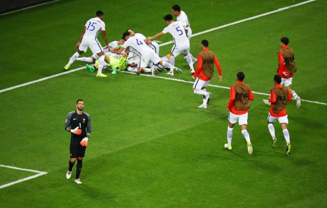 Chile’s Claudio Bravo celebrates with team mates after saving from Portugal’s Nani during the penalty shoot out as Portugal’s Rui Patricio looks dejected during the Confed Cup semi-final on Kazan on Wednesday