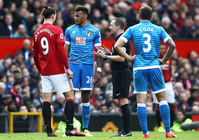 Bournemouth'S Tyrone Mings and Manchester United'S Zlatan Ibrahimovic clash