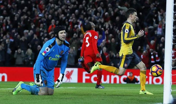 Liverpool's Georginio Wijnaldum celebrates scoring their third goal as Arsenal's Petr Cech looks dejected