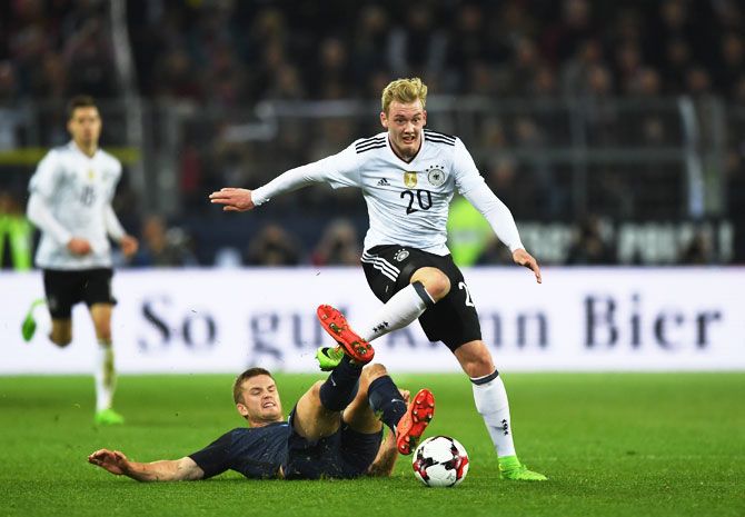 Germany's Julian Brandt is tackled by England's Eric Dier