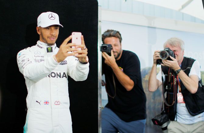 Mercedes driver Lewis Hamilton takes a selfie during the driver portrait session at the first race of the year at the Australian F1 GP in Melbourne, on Thursday, March 23