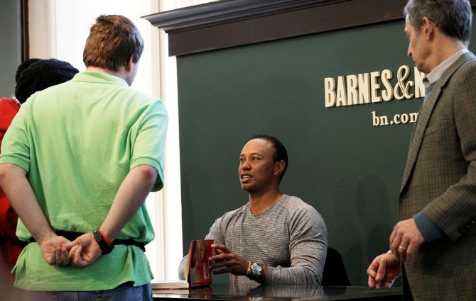 Golfer Tiger Woods signs copies of his new book The 1997 Masters: My Story’ at a book signing event at a Barnes & Noble store in New York City, New York, US, on Monday, March 20
