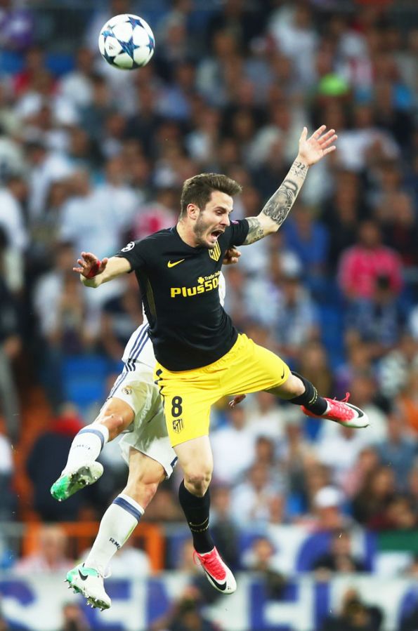 tletico Madrid's Saul Niguez is involved in an aerial possession with a Real Madrid player