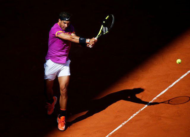 Rafael Nadal plays a backhad return during his match against Fabio Fognini