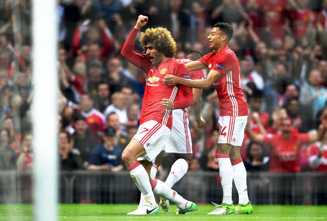 Manchester United's Marouane Fellaini celebrates scoring the first goal with teammates during their UEFA Europa League, semi-final second leg match against Celta Vigo at Old Trafford in Manchester, on Thursday